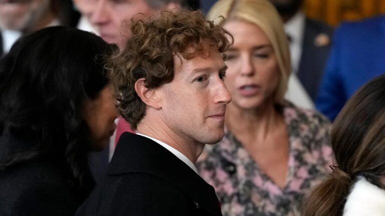 Mark Zuckerberg stands among attendees during the Meta Antitrust Trial, facing scrutiny over Facebook’s past acquisitions.