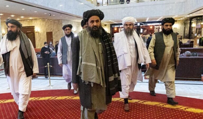 Senior Taliban leaders walk through a government building during a diplomatic visit to Moscow.