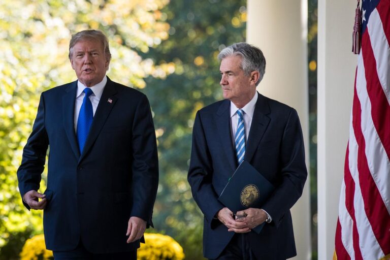 President Donald Trump and Federal Reserve Chair Jerome Powell walk together at the White House amid ongoing tensions over monetary policy.