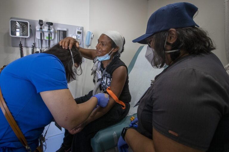 A woman receives medical care at a California clinic as part of the expanded Medi-Cal program, which now covers all low-income adults regardless of immigration status, following the state’s $2.8 billion funding allocation.