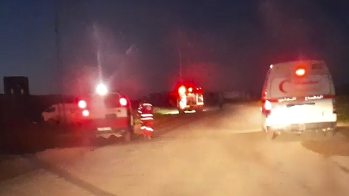 Emergency vehicles with flashing red lights seen at night in Rafah, moments before the deadly strike investigated in the Israeli probe into killings of Palestinian medics.