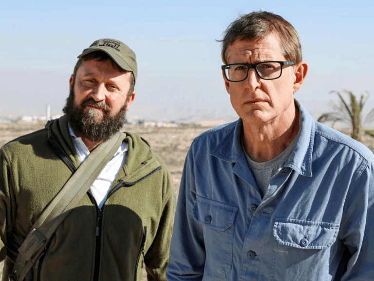 Louis Theroux stands alongside a West Bank settler during the BBC Israel-Palestine documentary, capturing the ideology behind settlement expansion.