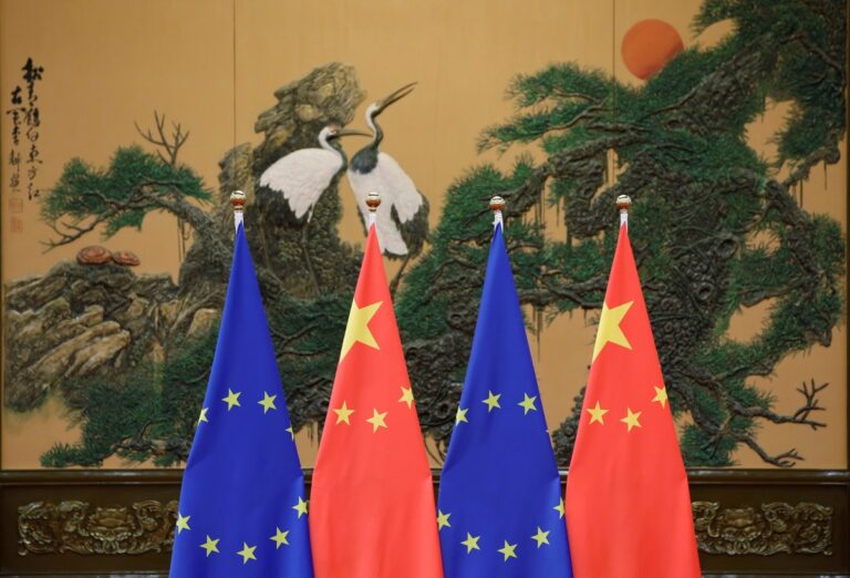 EU and Chinese flags displayed together during Beijing summit, symbolizing the China-EU strategic partnership.