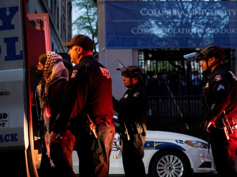 Police detain a masked demonstrator during the Columbia student protest suspensions outside university gates on May 7, 2025.
