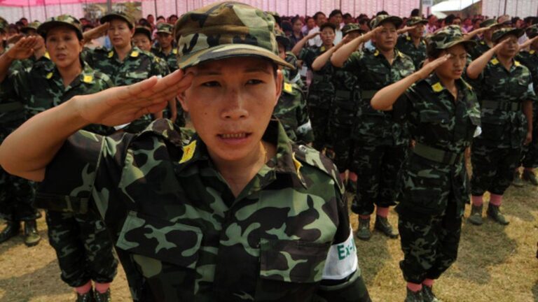US sanctions on Myanmar ethnic militia women soldiers saluting in uniform during a formation