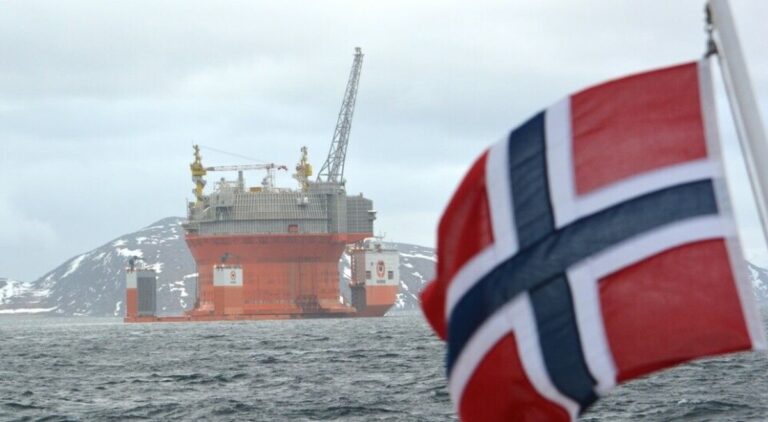 Norwegian flag flying near an oil platform as Norway’s wealth fund takes action over Israeli settlements in West Bank.