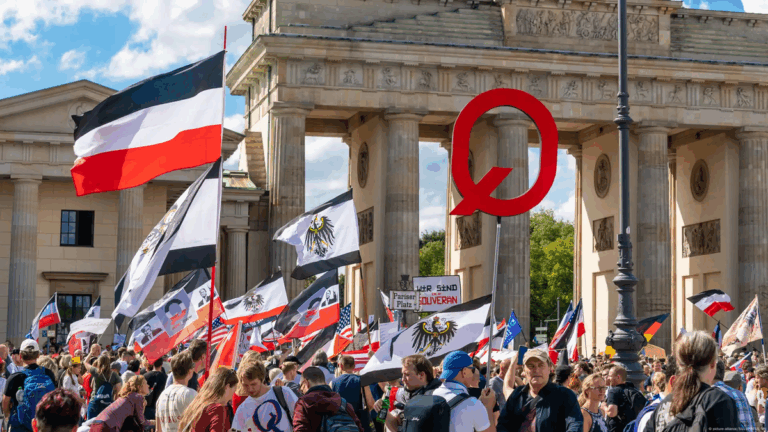 Protesters display flags and QAnon symbols during the Reichsbürger movement crackdown demonstration in Berlin