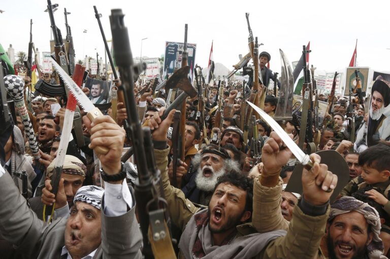 Armed Houthi supporters protest following the missile strike near Ben Gurion, intensifying rhetoric against Israel and its allies.