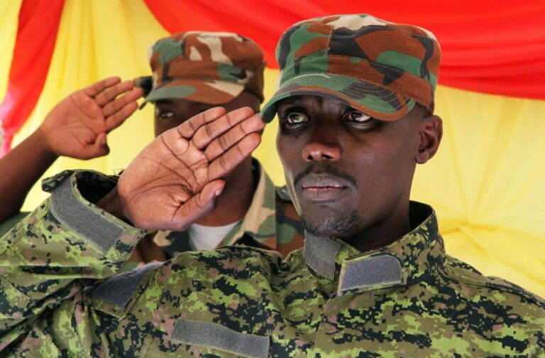Rwandan soldiers saluting during a military ceremony, amid rising scrutiny over the Rwanda-backed M23 rebel group’s role in Congo.