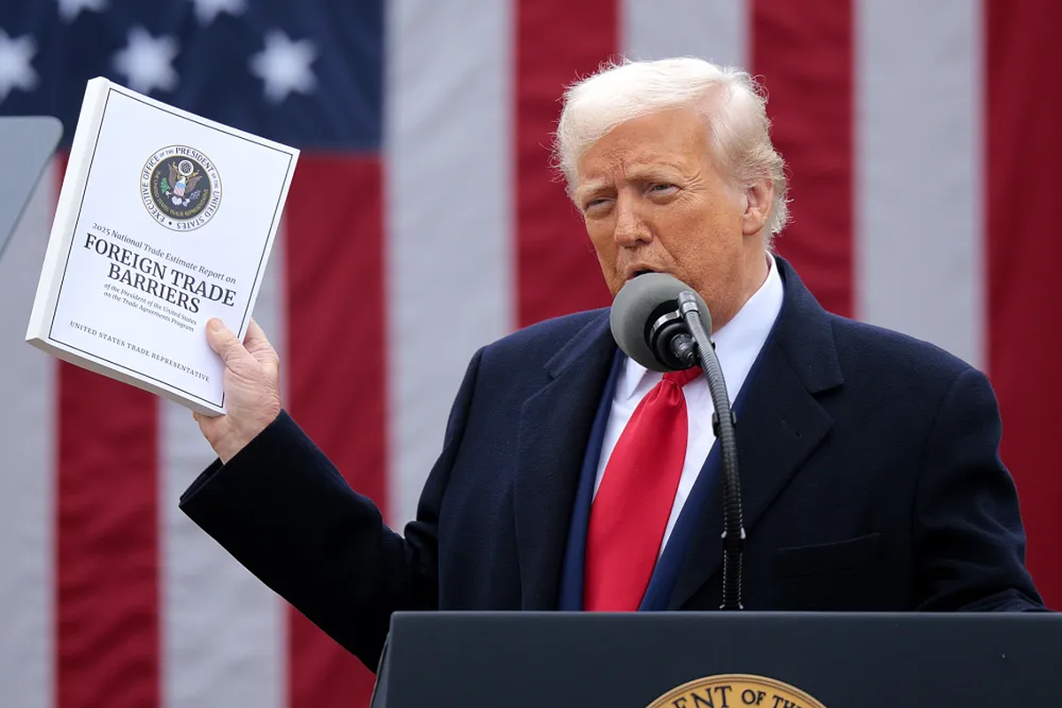 President Trump references trade concerns during the U.S.–China trade talks by holding the 2025 Foreign Trade Barriers report.